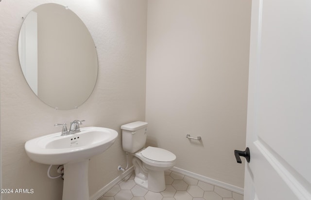 bathroom featuring tile patterned flooring and toilet