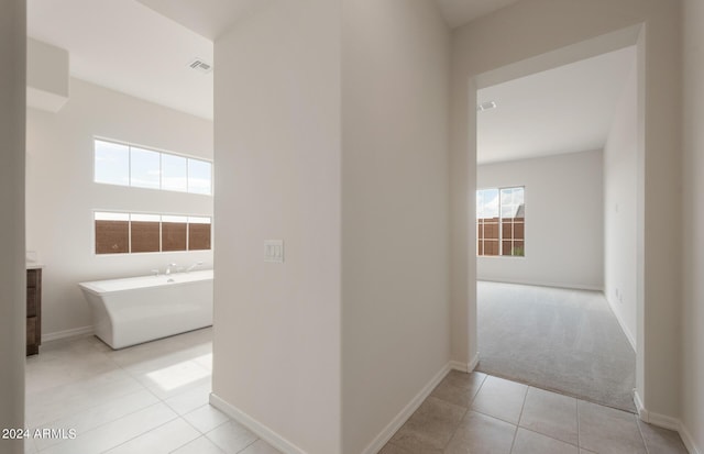 corridor featuring light tile patterned flooring