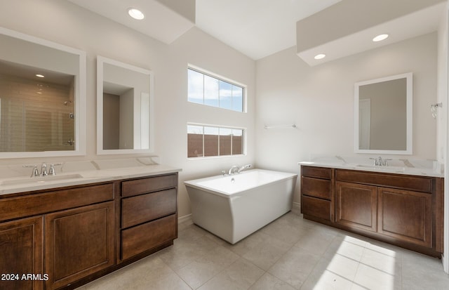 bathroom with tile patterned flooring, vanity, and plus walk in shower