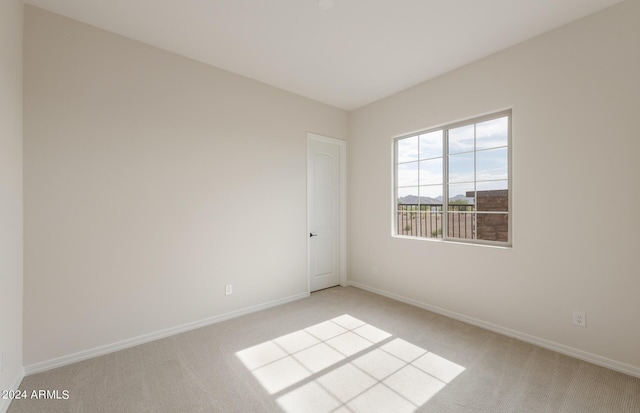 unfurnished room with light carpet