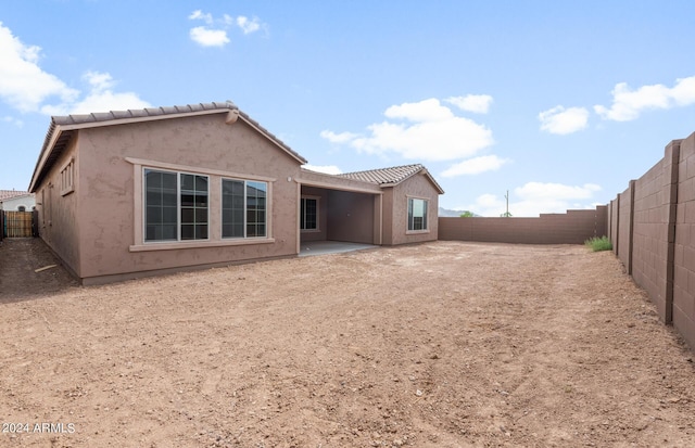 rear view of property featuring a patio area