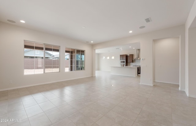 unfurnished living room featuring light tile patterned floors