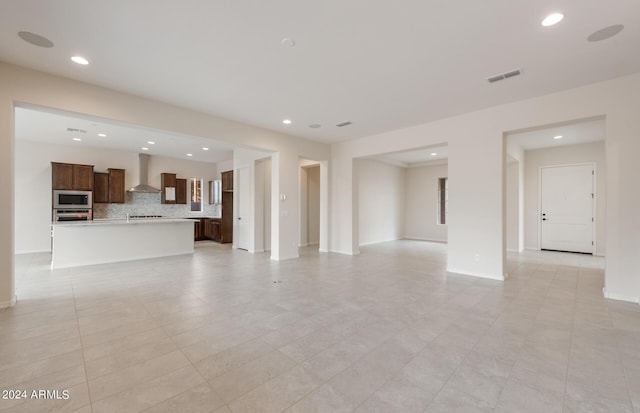 unfurnished living room featuring light tile patterned flooring