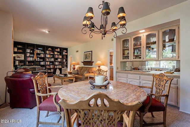 dining room featuring a chandelier and light carpet