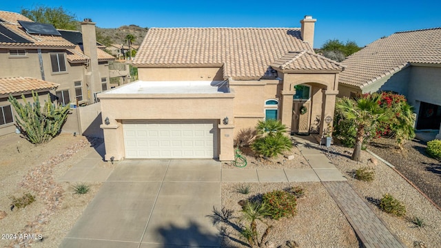 mediterranean / spanish house with a garage