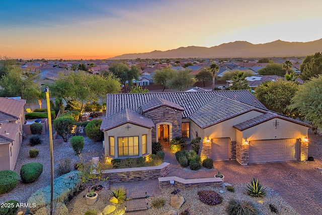 mediterranean / spanish-style home with a mountain view and a garage