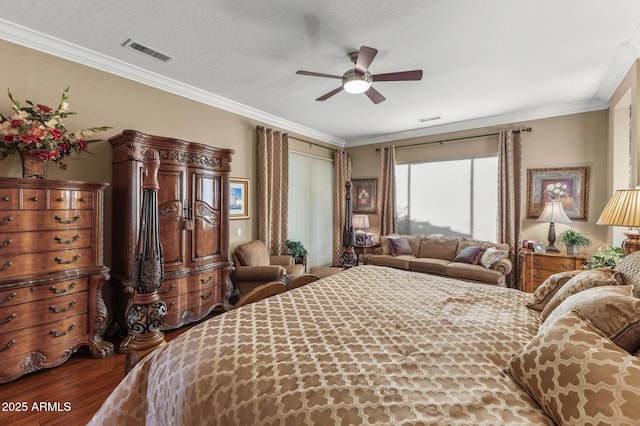 bedroom featuring ceiling fan, crown molding, wood-type flooring, and a textured ceiling