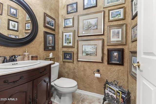 bathroom with tile patterned floors, vanity, and toilet