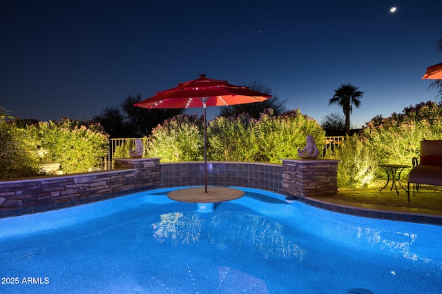 view of pool at night