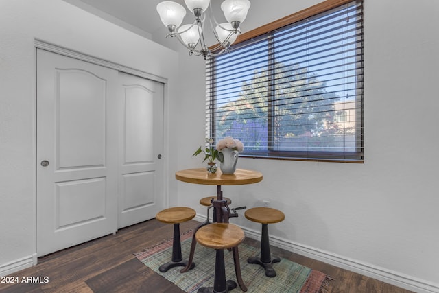 interior space with dark hardwood / wood-style flooring and a notable chandelier