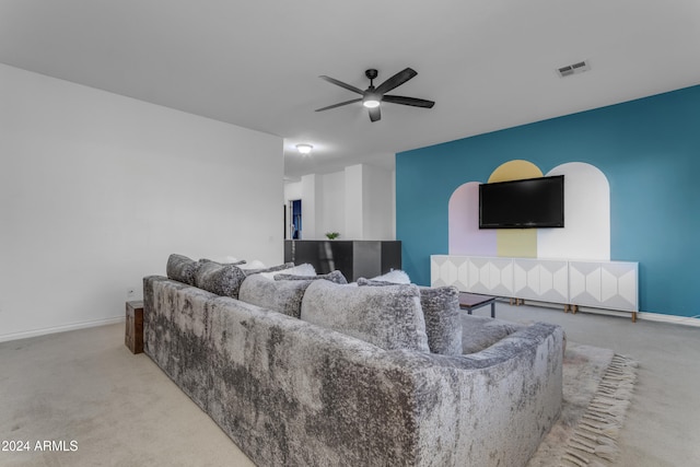 carpeted living room featuring ceiling fan