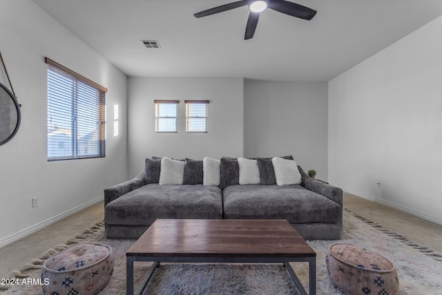 carpeted living room with ceiling fan