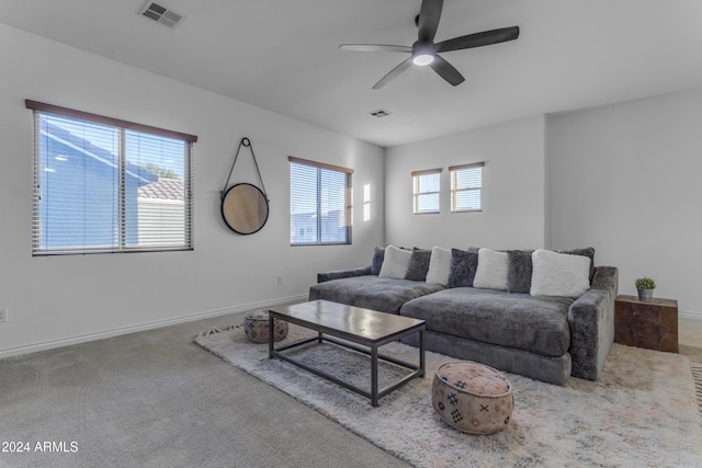 carpeted living room with ceiling fan