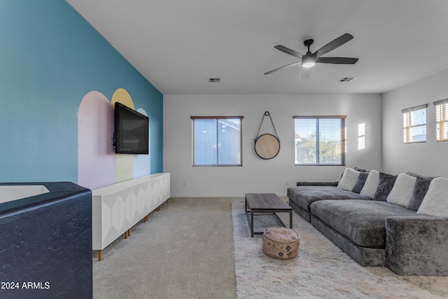 living room featuring ceiling fan, a healthy amount of sunlight, and carpet flooring