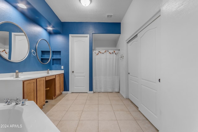 bathroom with tile patterned floors, independent shower and bath, and vanity