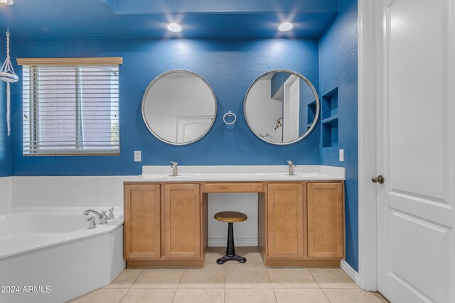 bathroom with vanity, tile patterned floors, and a bathing tub