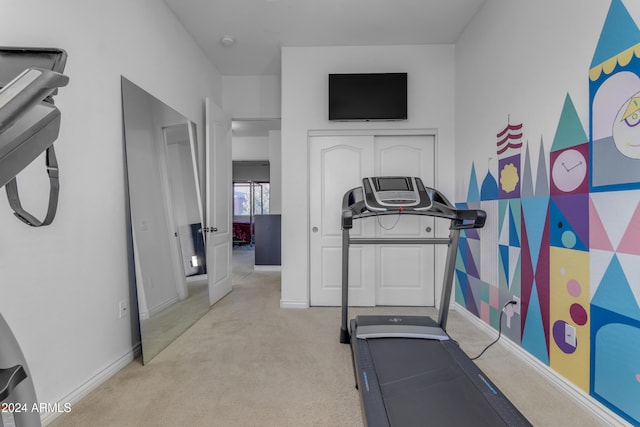 workout room featuring light colored carpet