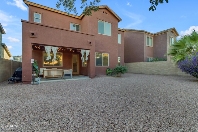 rear view of property featuring a patio