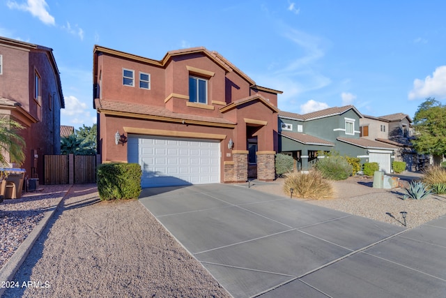 964 W Saguaro Ln, San Tan Valley, AZ 85143 - view of front of house featuring a garage, driveway, fence, stucco siding, and stone siding