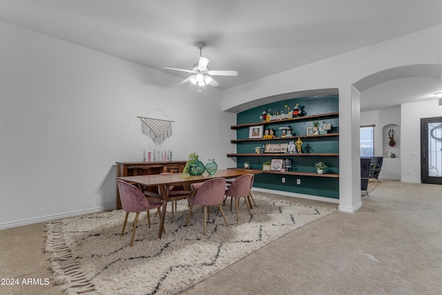 carpeted dining room featuring ceiling fan