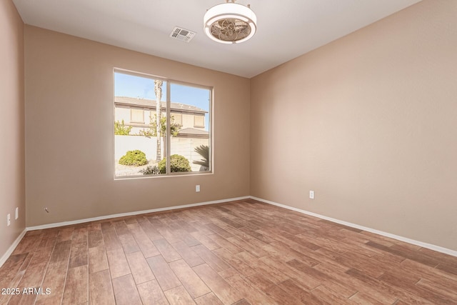 unfurnished room with light wood-type flooring