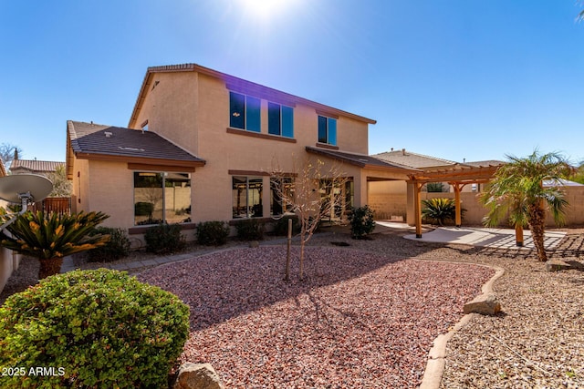 rear view of house featuring a patio area and a pergola