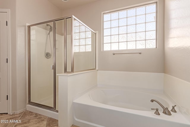 bathroom with shower with separate bathtub