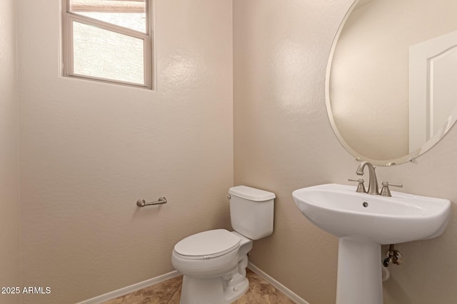 bathroom featuring toilet and sink