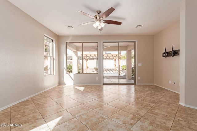 empty room featuring light tile patterned flooring and ceiling fan