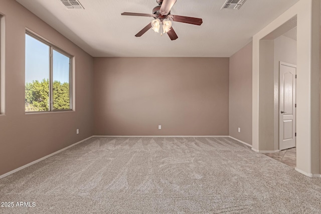 empty room with light colored carpet and ceiling fan