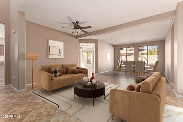 living area with light tile patterned floors, baseboards, and ceiling fan with notable chandelier