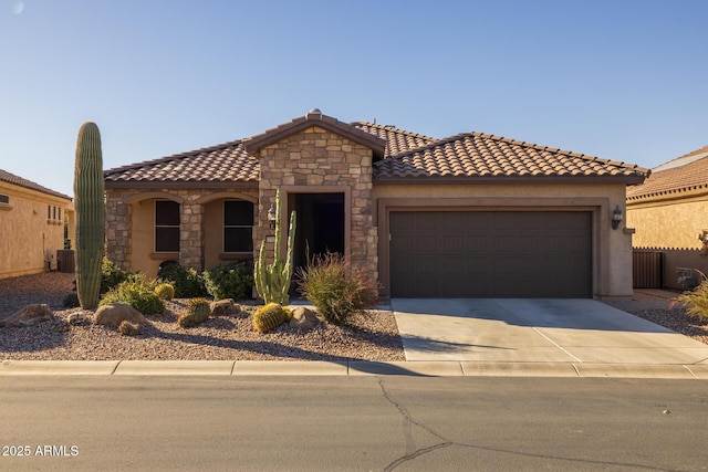 mediterranean / spanish home featuring cooling unit and a garage