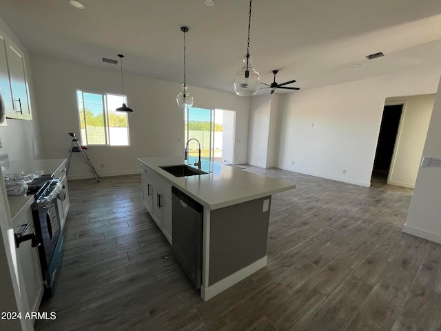 kitchen with a kitchen island with sink, white cabinetry, dark hardwood / wood-style flooring, and stainless steel appliances