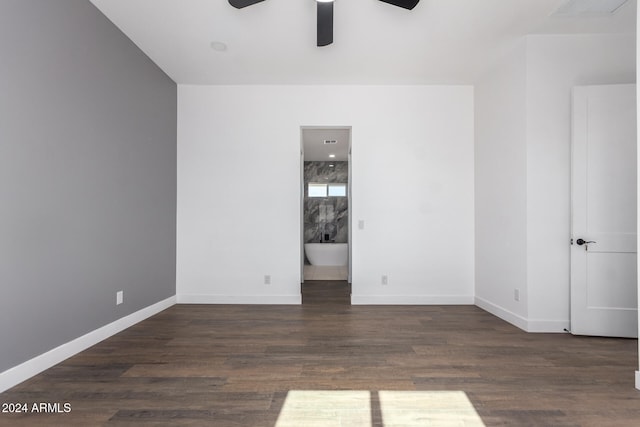 spare room featuring dark hardwood / wood-style flooring and ceiling fan