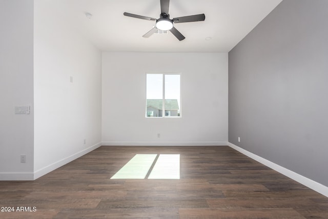 empty room with ceiling fan and dark wood-type flooring