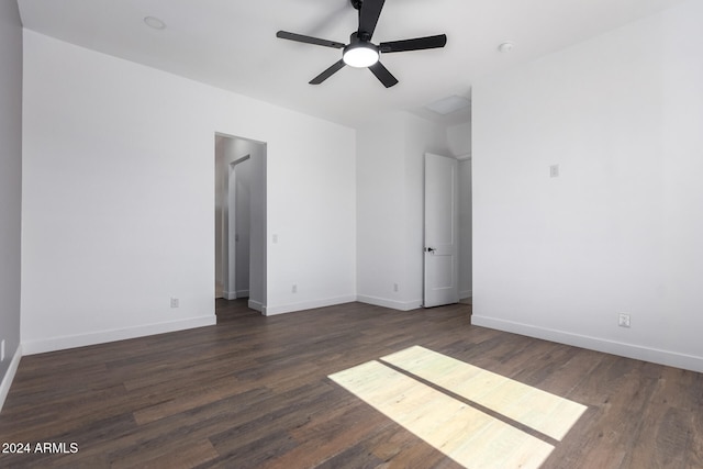 spare room featuring dark hardwood / wood-style flooring and ceiling fan