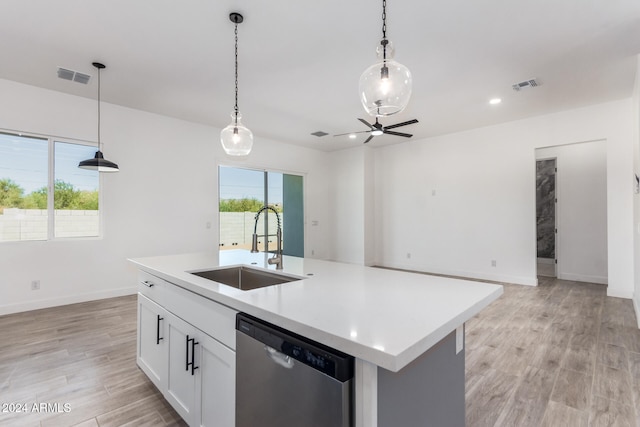 kitchen featuring a kitchen island with sink, white cabinets, hanging light fixtures, sink, and stainless steel dishwasher