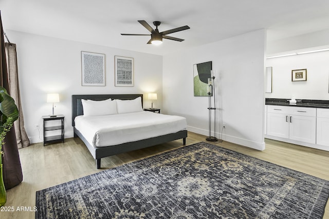 bedroom with baseboards, a ceiling fan, and light wood-style floors