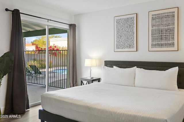 bedroom featuring wood finished floors and access to outside