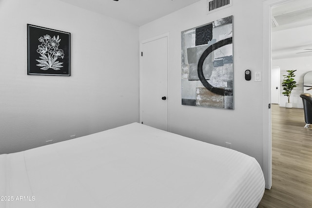 bedroom with wood finished floors and visible vents