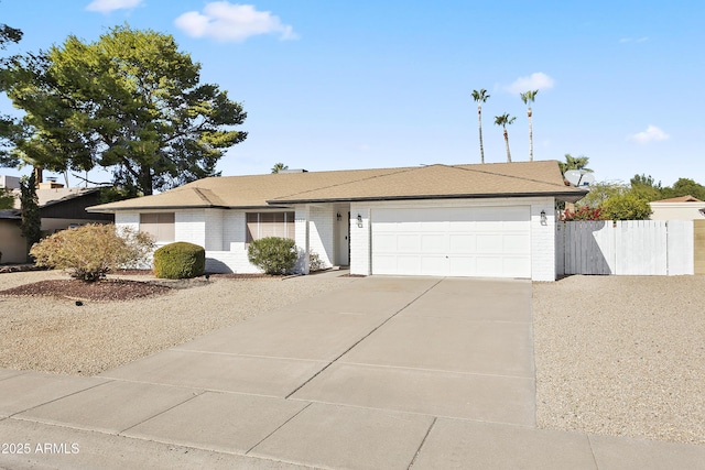 ranch-style home featuring brick siding, driveway, fence, and a garage