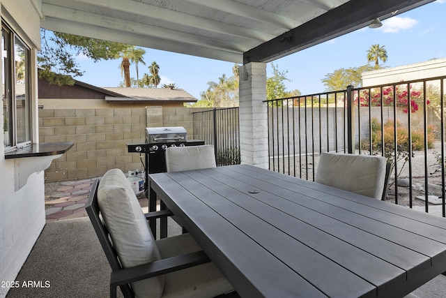 deck featuring a fenced backyard, outdoor dining space, and grilling area