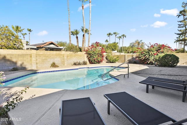 view of swimming pool featuring a fenced backyard, a patio, and a fenced in pool