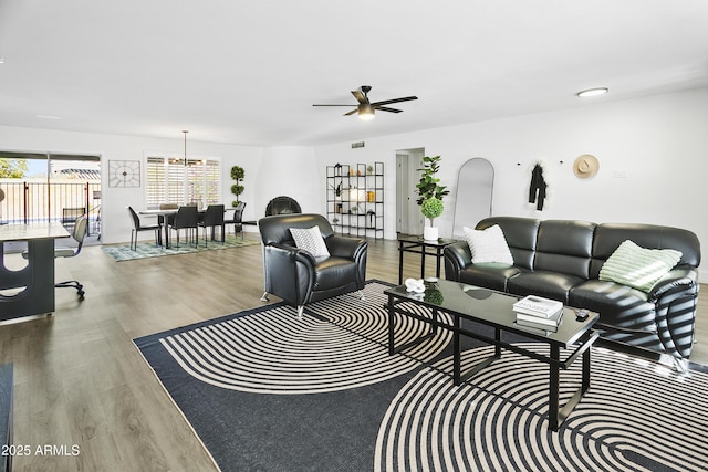 living room featuring wood finished floors and ceiling fan