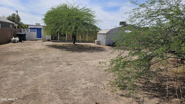 view of yard featuring fence and a gate
