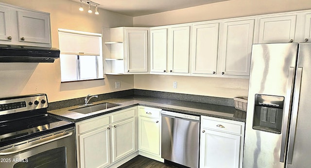 kitchen with stainless steel appliances, a sink, open shelves, dark countertops, and ventilation hood