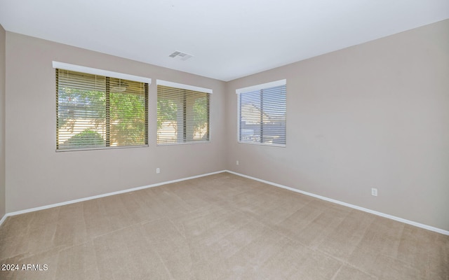 empty room featuring light carpet