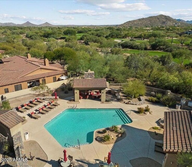 community pool featuring a mountain view and a patio