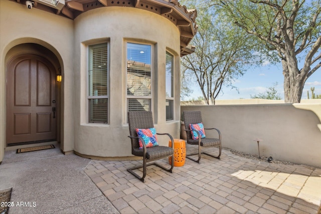 doorway to property with stucco siding and a patio