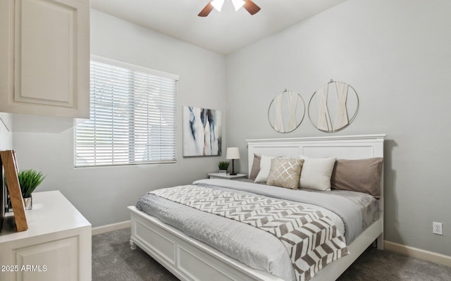 bedroom featuring dark carpet, baseboards, and ceiling fan